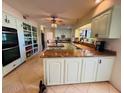 Spacious kitchen featuring custom cabinetry, stone countertops, and stainless-steel appliances at 94 Biltmore Estates Dr, Phoenix, AZ 85016