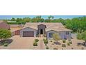 Beautiful single-story home with manicured desert landscaping and a brick driveway at 23090 S 201St St, Queen Creek, AZ 85142