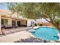 Inviting backyard pool with a covered patio, perfect for outdoor entertaining and relaxation at 23090 S 201St St, Queen Creek, AZ 85142