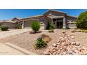 Welcoming single-story residence with a two-car garage and xeriscaping for low water usage at 10342 E Obispo Ave, Mesa, AZ 85212