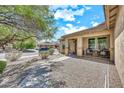 Exterior view of a home with desert landscaping, a sidewalk and a charming porch area at 1147 E Harvest Rd, San Tan Valley, AZ 85140