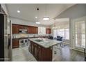 Spacious kitchen featuring an island with countertop, stainless steel appliances, and natural light at 14039 S 33Rd Way, Phoenix, AZ 85044
