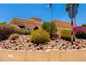 Exterior home view featuring a variety of desert landscaping and flowering bushes at 15630 N 20Th St, Phoenix, AZ 85022