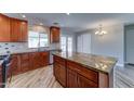 Well-lit kitchen with granite countertops, stainless steel appliances, and stylish wood look tile flooring at 1716 W Villa Theresa Dr, Phoenix, AZ 85023