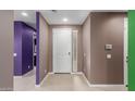 A modern foyer featuring neutral walls and a bright white front door at 17352 W Red Fox Rd, Surprise, AZ 85387