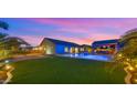 Relaxing backyard featuring a sparkling pool, covered patio and lush turf at 17850 E Bronco Ct, Queen Creek, AZ 85142