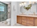 Elegant bathroom featuring a dual sink vanity, modern fixtures, and a tiled shower at 2712 N 20Th Dr, Phoenix, AZ 85009