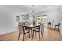 Bright dining room with a modern chandelier, a dining table set, and backyard access at 2712 N 20Th Dr, Phoenix, AZ 85009