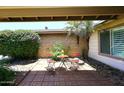 Cozy outdoor patio area, perfect for relaxing with a small table and chairs set among lush greenery at 3033 W Tierra Buena Ln, Phoenix, AZ 85053