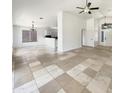 Bright living room with tile floors, neutral paint, and a view to the kitchen at 317 E Nunneley Rd, Gilbert, AZ 85296