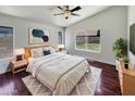 Comfortable main bedroom with modern decor, ceiling fan, and backyard views at 317 E Nunneley Rd, Gilbert, AZ 85296