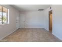 Bright living room showcasing neutral colors, tiled floor, and natural light at 3423 W Bloomfield Rd, Phoenix, AZ 85029