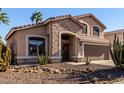 Inviting single-Gathering home with stone accents, desert landscaping, and a two-car garage at 3619 N 104Th Dr, Avondale, AZ 85392