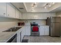 Kitchen featuring white cabinets and stainless steel appliances at 4201 E Camelback Rd # 74, Phoenix, AZ 85018