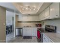 Bright kitchen featuring white cabinets and stainless steel appliances at 4201 E Camelback Rd # 74, Phoenix, AZ 85018