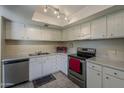 Bright kitchen featuring white cabinets and stainless steel appliances at 4201 E Camelback Rd # 74, Phoenix, AZ 85018