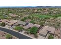 Expansive aerial view of the community featuring desert landscaping, single-story homes and golf course at 42122 N Anthem Springs Rd, Anthem, AZ 85086