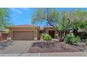 Inviting single-story home featuring xeriscaping with mature trees and a two car garage at 42122 N Anthem Springs Rd, Anthem, AZ 85086