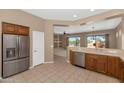 Open-concept kitchen with stainless steel appliances, tile flooring, and a view into the living room at 42122 N Anthem Springs Rd, Anthem, AZ 85086