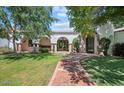 Charming front entrance with a brick walkway, arched entryway, and well-maintained landscaping, exuding curb appeal at 5225 N 23Rd St, Phoenix, AZ 85016