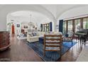 Spacious living room featuring vaulted ceilings, hardwood floors, stylish furniture, and an abundance of natural light at 5225 N 23Rd St, Phoenix, AZ 85016