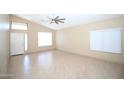 Bright living room featuring tile floors, neutral paint, and a ceiling fan at 5437 W Bluefield Ave, Glendale, AZ 85308
