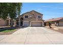 A two-story home with a three-car garage, landscaped front yard, and neutral colored paint at 5744 E Jacaranda St, Mesa, AZ 85205