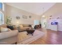 Bright living room with vaulted ceiling, wood floors, neutral color scheme, and stylish furnishings at 5744 E Jacaranda St, Mesa, AZ 85205