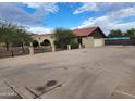 Spacious home with a brick facade, arched entryways, two-car garage and an expansive paved driveway at 5801 N 73Rd Ave, Glendale, AZ 85303