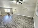 Spacious living room features gray flooring, and large windows offering lots of natural light at 5813 W Gelding Dr, Glendale, AZ 85306
