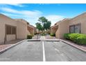 Exterior parking area with desert landscaping providing a tranquil neighborhood setting at 5813 W Gelding Dr, Glendale, AZ 85306