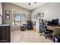 Spacious home office features a large window for natural light, neutral walls and tiled flooring at 9912 W Illini St, Tolleson, AZ 85353