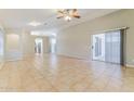Bright living area with tile floors, ceiling fan, and sliding glass door to the patio at 1048 N Arroya --, Mesa, AZ 85205