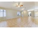 Open-concept living area featuring tile floors, neutral paint, and a ceiling fan at 1048 N Arroya --, Mesa, AZ 85205