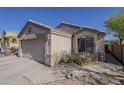 Single Gathering home featuring a two-car garage, desert landscaping, and sandstone accents at 11101 E Abilene Ave, Mesa, AZ 85208