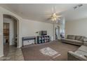 Spacious living room with plush carpet, ceiling fan, and neutral paint palette at 11101 E Abilene Ave, Mesa, AZ 85208