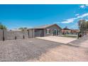 View of property with desert landscaping, block wall, and gate leading to the main house at 11450 E Elton Ave, Mesa, AZ 85208