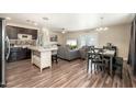 Open-concept living space with modern furnishings, seamlessly connecting the kitchen, dining, and living areas at 11450 E Elton Ave, Mesa, AZ 85208