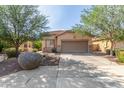 Charming single-story home with well-maintained landscaping and a two-car garage at 12910 W Glenrosa Dr, Litchfield Park, AZ 85340