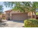 Single-story home with a tile roof, neutral stucco exterior, and a two-car garage at 12910 W Glenrosa Dr, Litchfield Park, AZ 85340
