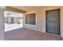 Welcoming covered front porch with brick flooring and a security door at 1336 E Laurel Pl, Casa Grande, AZ 85122