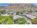 Stunning aerial view of home showcasing tile roof, desert landscaping, and mountain views at 1409 E Goldenrod St, Phoenix, AZ 85048