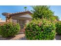 Landscaped front yard featuring colorful bushes and desert landscaping at 15011 W Verde Ln, Goodyear, AZ 85395