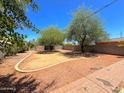Large backyard featuring desert landscaping, a privacy fence, and a brick patio area at 1629 N 17Th Ave, Phoenix, AZ 85007