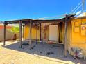 Covered patio area with brick flooring, providing a shaded outdoor space. Needs Repairs at 1629 N 17Th Ave, Phoenix, AZ 85007