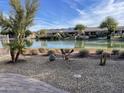 Beautiful backyard view of the lake and nearby houses on a sunny day at 16727 S 178Th Dr, Goodyear, AZ 85338