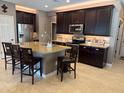 Gourmet kitchen featuring stainless steel appliances, granite countertops, and large island at 16727 S 178Th Dr, Goodyear, AZ 85338