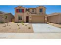 Inviting two-story home with red shutters and a low-maintenance desert landscape at 18365 W Villa Hermosa Ln, Surprise, AZ 85387