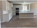Modern kitchen with white cabinetry, stainless steel appliances, and ample counter space at 18365 W Villa Hermosa Ln, Surprise, AZ 85387