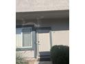 The entrance features a neutral-colored door, a window with white trim, and a small bush at 2311 E Hartford Ave # 38, Phoenix, AZ 85022